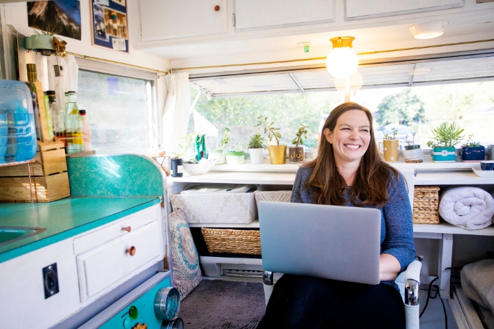 happy woman working from her rv