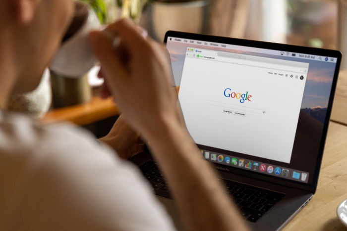 a man browsing the web through Google search